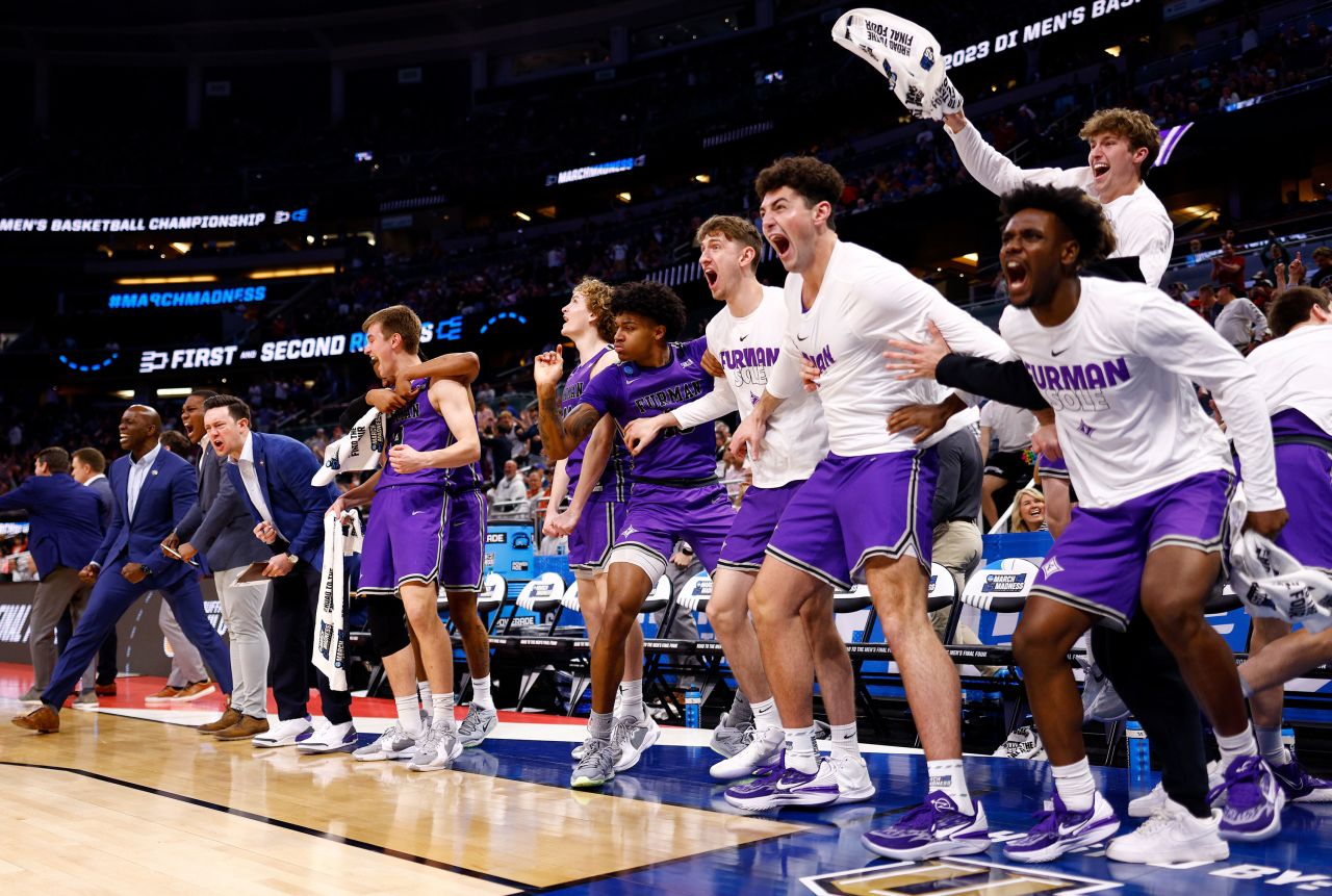 Players on the Furman Paladins bench react during their game against the Virginia Cavaliers in Orlando, Florida, on Thursday, March 16. Furman upset Virginia 68-67 in the first round of March Madness.